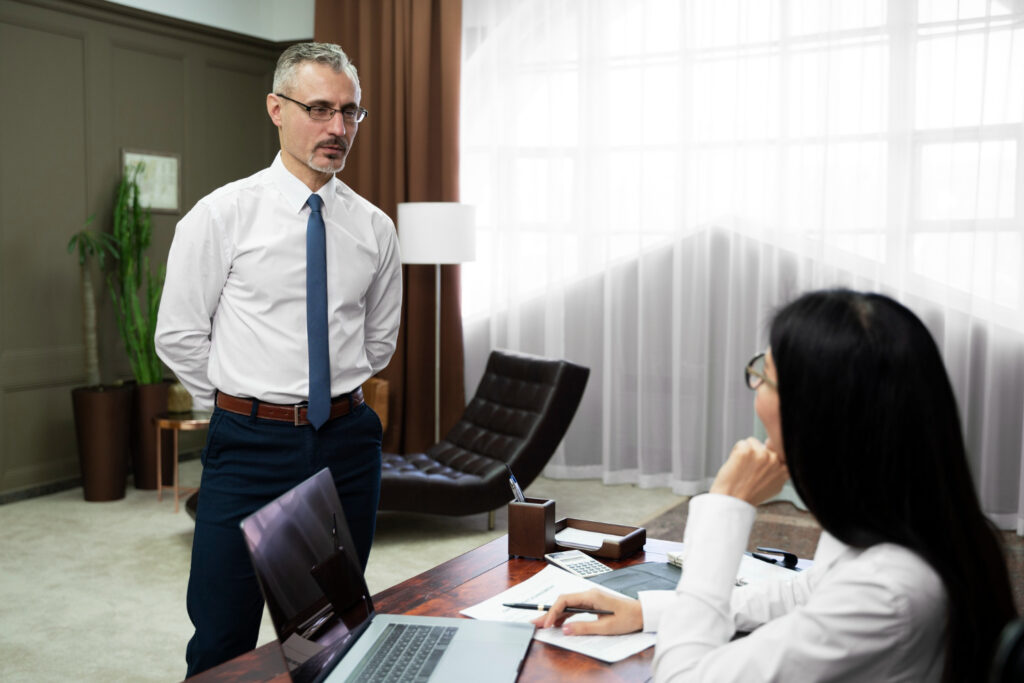 Man and woman discussing AFSL responsible manager hiring in office.